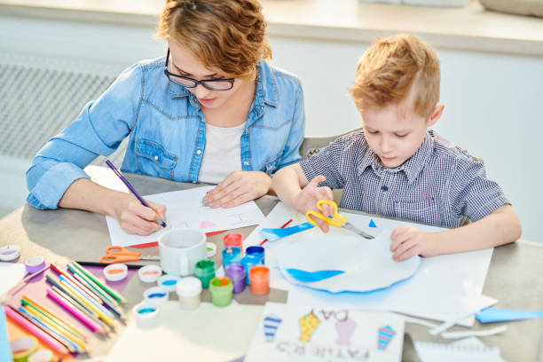 istock Mother and Son Crafting Together at Home 986044714