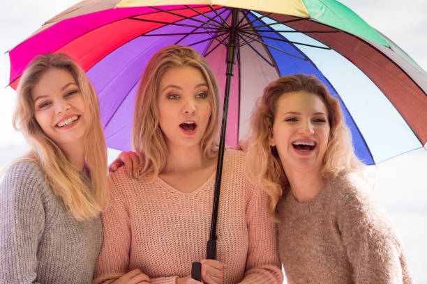 istock Three women under colorful umbrella 986052652