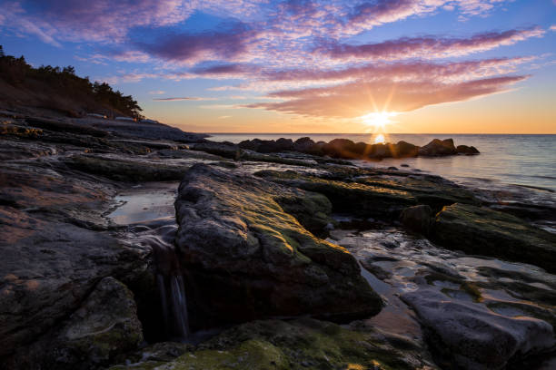 istock Stones waterfall and cliffs at the sea 986055246