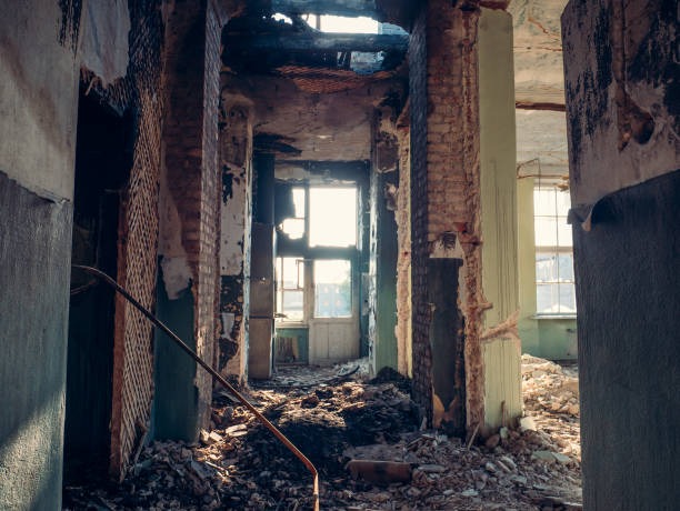 istock Corridor in ruins of abandoned building, garbage and broken walls without doors. Interior after war or other disaster 986056622