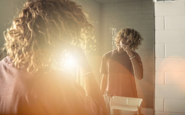 istock Teen brushing teeth 986061258
