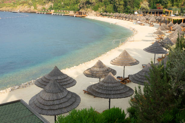 istock Beach chairs with umbrellas and beautiful sand beach 986080464