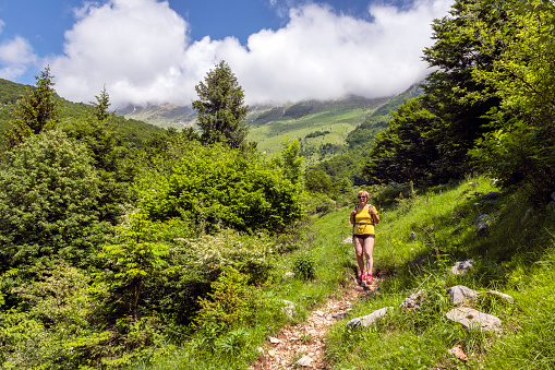 Senior woman Hiking in Julian Alps in Spring, Primorska, Slovenia, Europe,no logos, Nikon D850