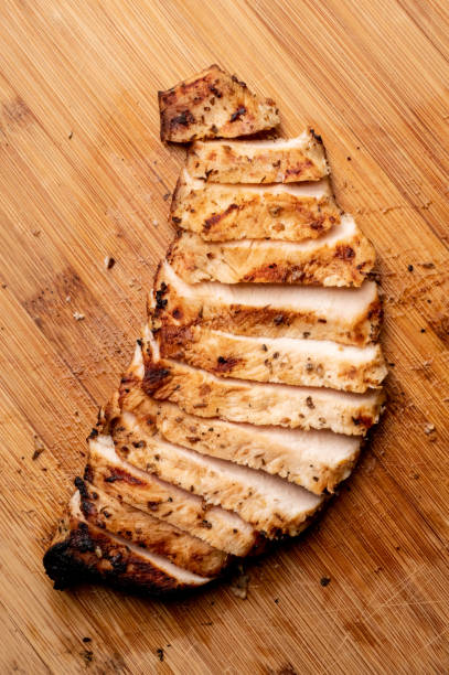 Sliced Grilled Chicken Breast on a Bamboo Cutting Board