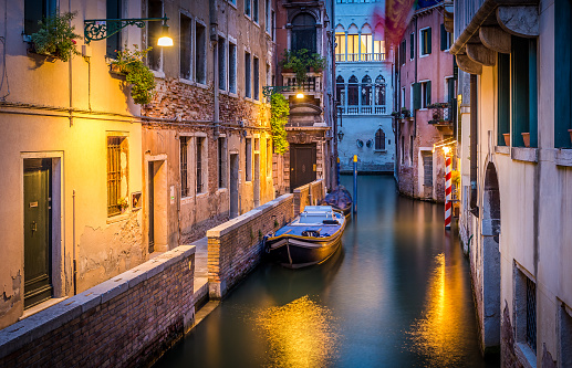 Narrow canal in Venice in the evening