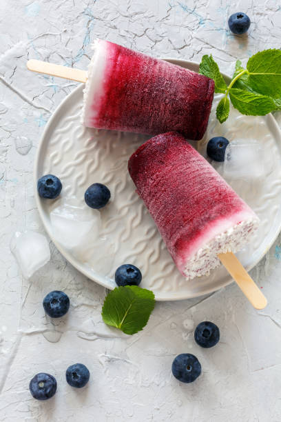 istock Homemade coconut popsicles with fresh berry. 986091512