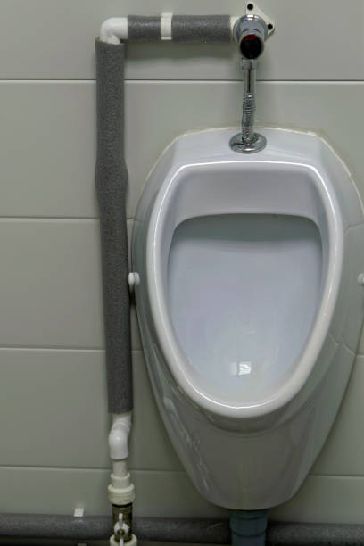 istock White Urinal in a public men's room 986092300