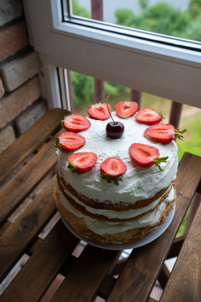 istock Strawberry cake on wooden table 986099574