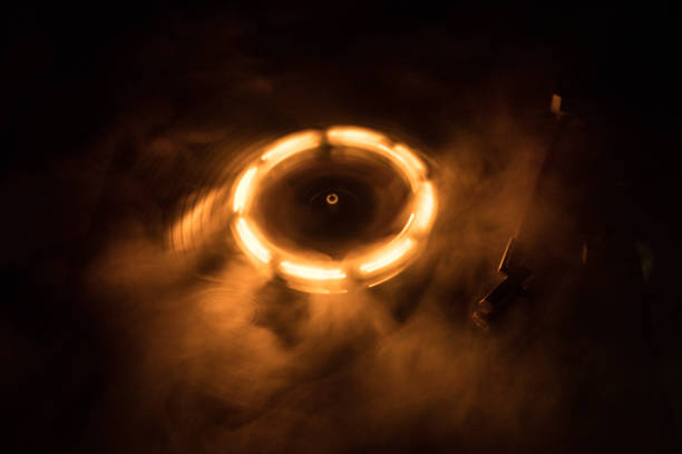 istock Turntable playing vinyl with glowing abstract lines concept on dark background 986107162