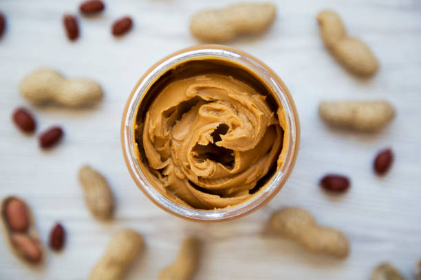 istock Jar of creamy peanut butter, top view. Close-up. 986110962