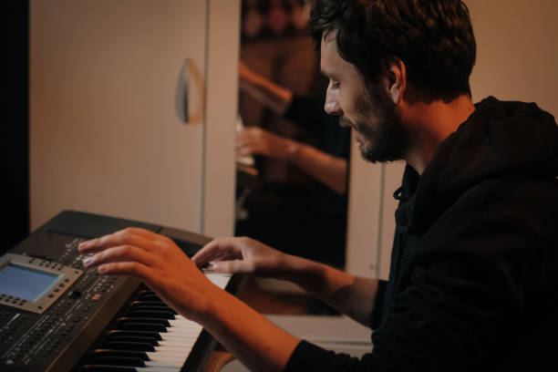 istock Focused Young Artist Playing Electric Piano 986110992