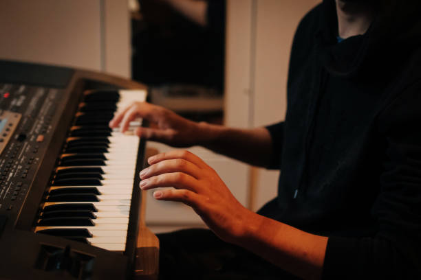 istock Focused Young Artist Playing Electric Piano 986110994