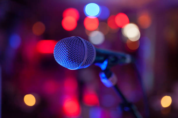 istock Image of a microphone in the concert hall. 986111320
