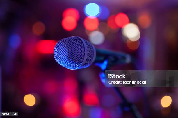 Image Of A Microphone In The Concert Hall Stock Photo - Download Image Now - Microphone, Event, Lighting Equipment