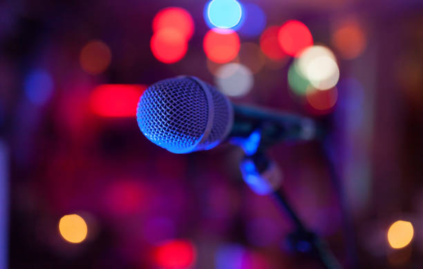 istock Image of a microphone in the concert hall. 986111326