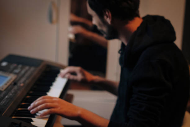 istock Focused Young Artist Playing Electric Piano 986111848