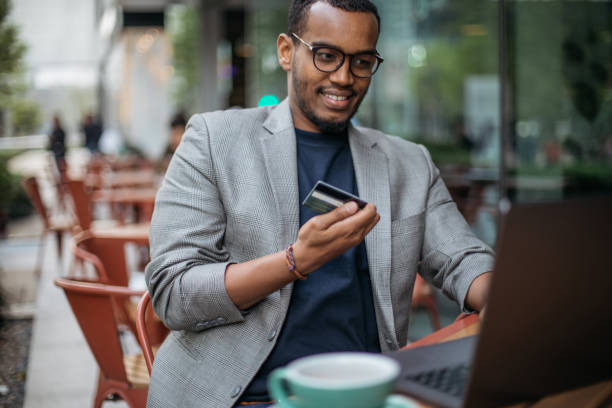 istock Man sitting in coffee shop and using laptop 986112094