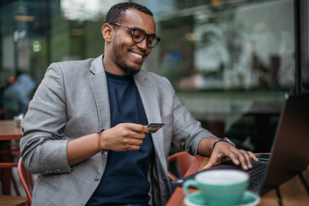 istock Man in coffee shop using laptop 986112244