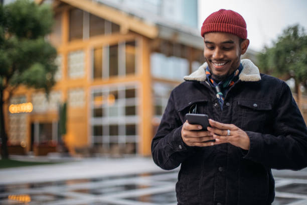 istock Man texting on phone outdoors 986115026