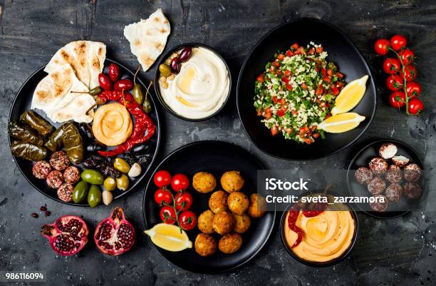 Arabic Traditional Cuisine Middle Eastern Meze Platter With Pita Olives Hummus Stuffed Dolma Labneh Cheese Balls In Spices Mediterranean Appetizer Party Idea Stock Photo - Download Image Now