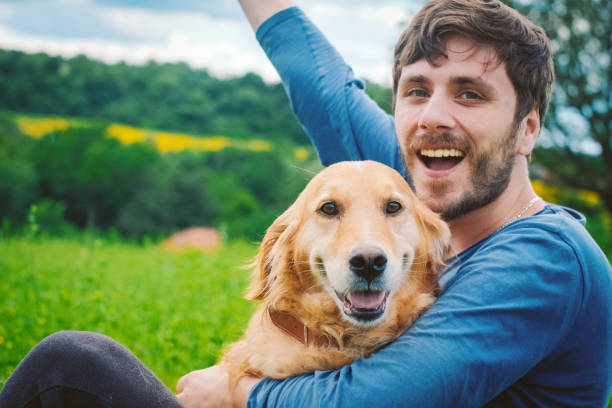 istock Guy and his dog, golden retriever, nature 986116416