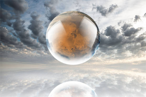 istock Crystal ball reflecting globe of the mars on clouds background 986141370