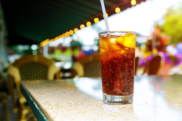 Ice Cold Cola with drinks a Lemon on cocktails an Outdoor Patio