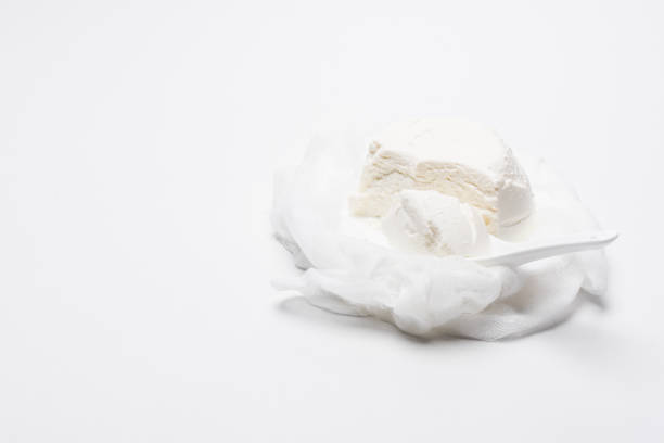istock homemade cottage cheese on cheesecloth with spoon on white surface 986157950