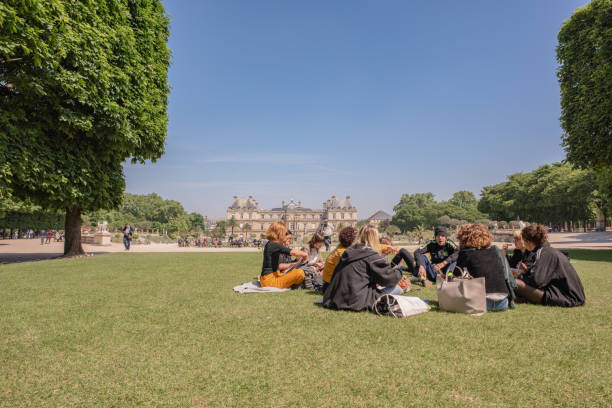 College class meeting for lunch in the Luxembourg Gardens in Paris stock photo