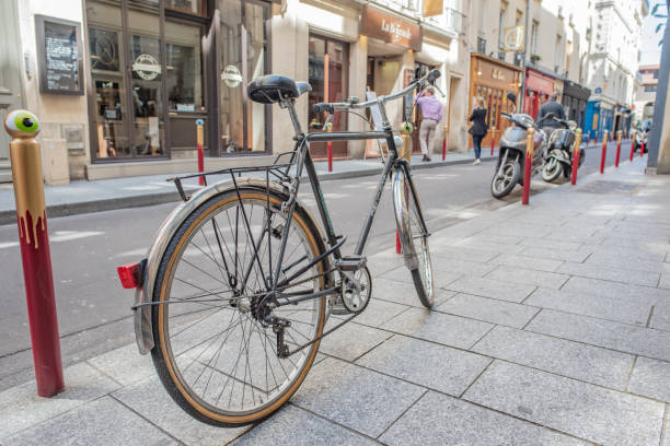 Paris / France - May 18, 2018: A bicycle parked along the quaint, colorful streets of the famous Saint-Germain des Pres neighborhood, in Paris' Left Bank, a very bicycle friendly area.