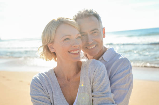 istock Affectionate mature couple embracing at the beach. 986192240