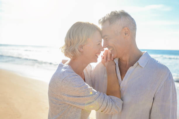 istock Affectionate mature couple embracing at the beach. 986192248