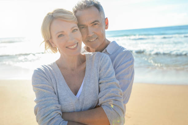 istock Affectionate mature couple embracing at the beach. 986192252