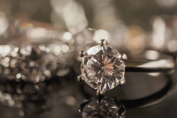 istock Luxury Jewelry diamond rings with reflection on black background 986208010