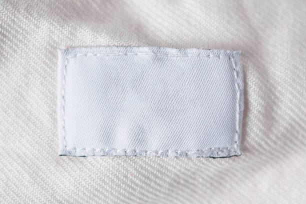 istock White blank laundry care clothes label on cotton shirt 986208134