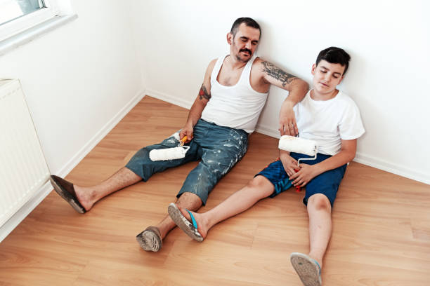 Painter man and son  tired, lying on the floor Painter man and son  tired, lying on the floor lazy construction laborer stock pictures, royalty-free photos & images