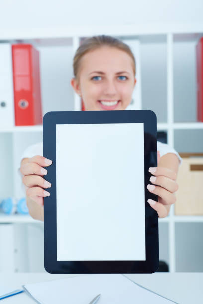 istock Smiling successful businesswoman showing digital tablet screen 986219774