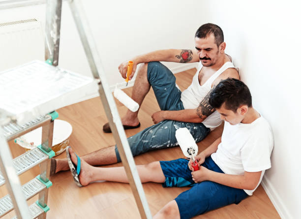 Painter man and son  tired, lying on the floor Painter man and son  tired, lying on the floor lazy construction laborer stock pictures, royalty-free photos & images