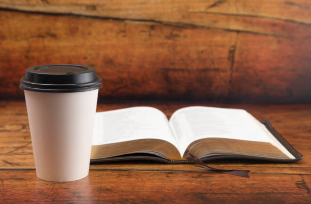 istock Bible and a Cup of Coffee in a Disposable Paper Cup 986228130