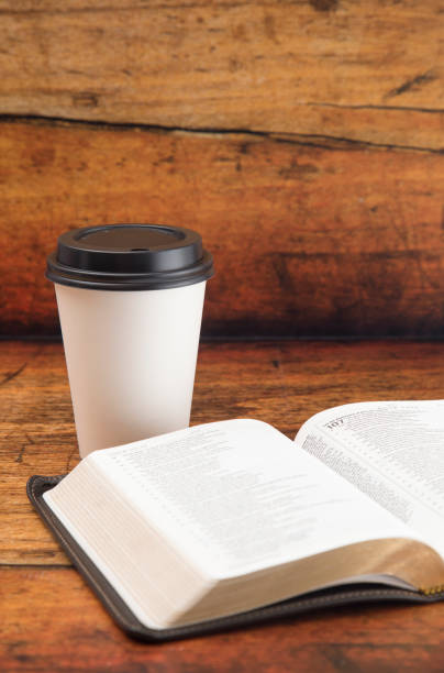 istock Bible and a Cup of Coffee in a Disposable Paper Cup 986228332