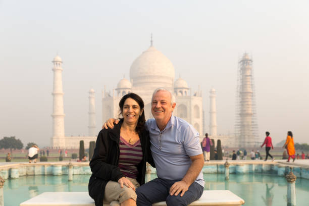 istock Mature Couple embracing on Taj Mahal, Agra, India 986255452