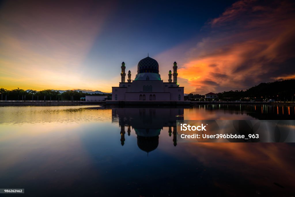 Floating City Mosque Majestic view of floating city mosque with clear reflection on the water during sunrise. Arabic Style Stock Photo
