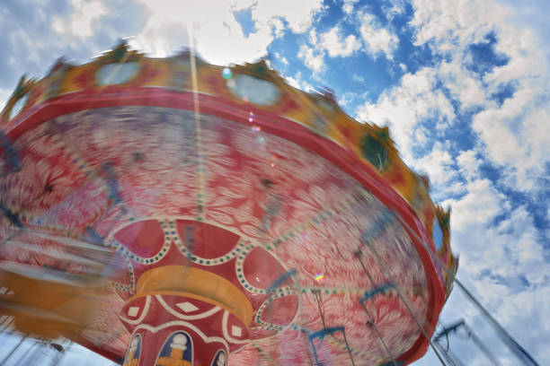 istock Carousel in motion in an amusement park 986271730