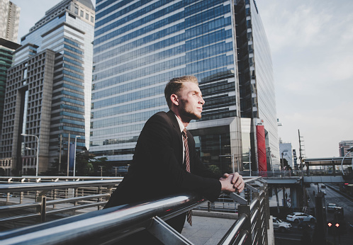 Modern Business Confident Freedom Financial. Business Caucasian man In Suit Standing Happy Successful on city background.