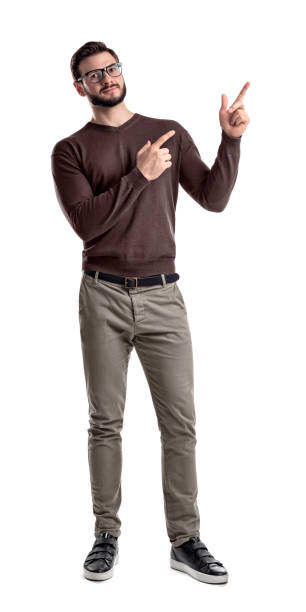 istock A bearded man in smart casual clothes looks in front to camera and points sideways with both hands and index fingers 986331432