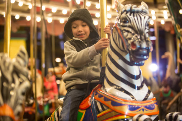 Kids enjoying a them parks Merry go round