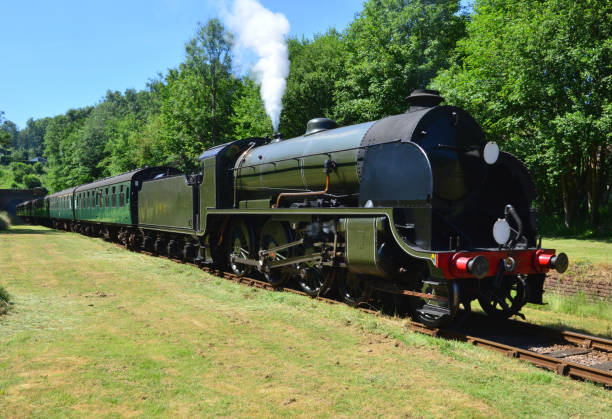 istock Vintage steam train emerging from a tunnel on a heritage railway line. 986342156