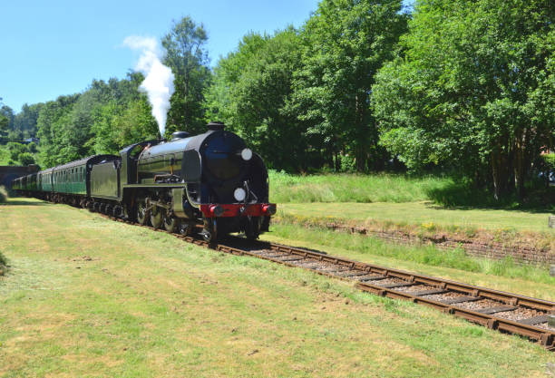 istock Vintage steam train emerging from a tunnel on a heritage railway line. 986343190