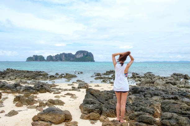 istock Young woman relaxing enjoy on tropical beach 986352540
