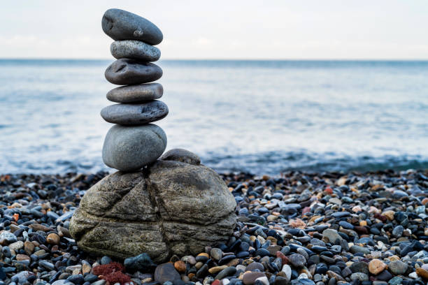istock Stone tower of pebbles on sea shore 986384248